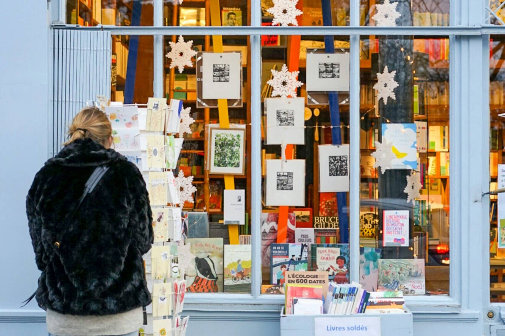 woman picking card at boutique
