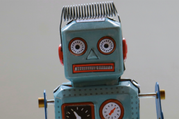 tin toy robot representing AI