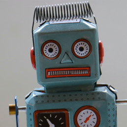 tin toy robot representing AI